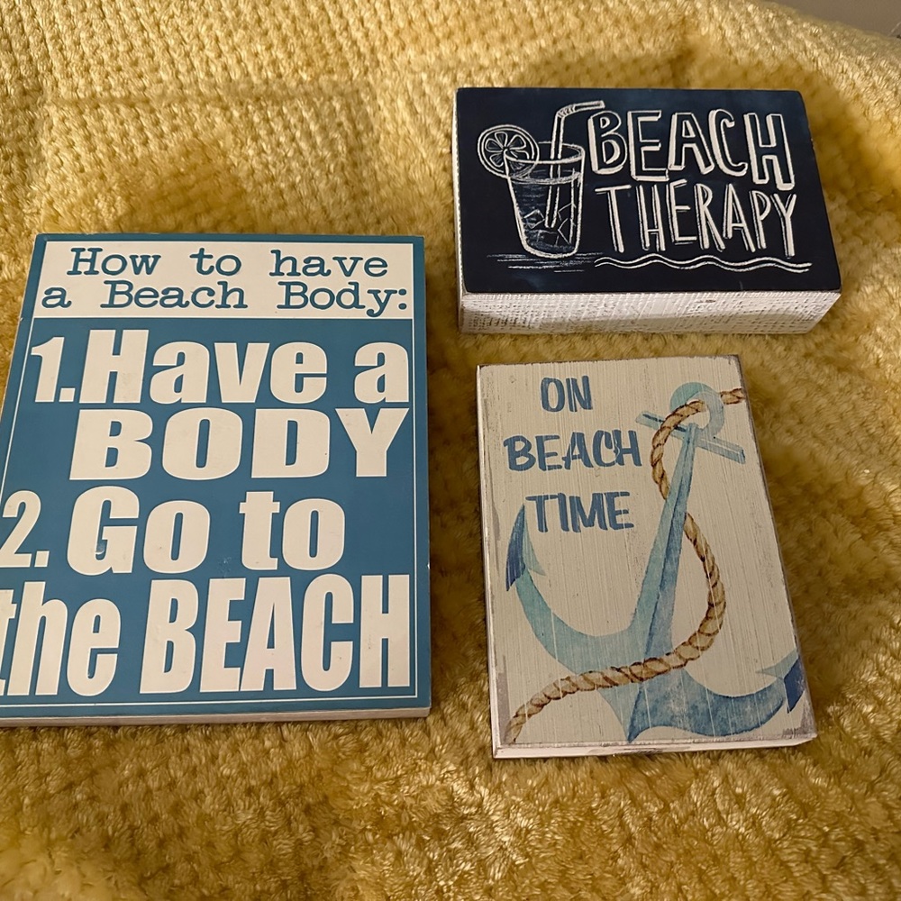 Three Beach Themed Signs